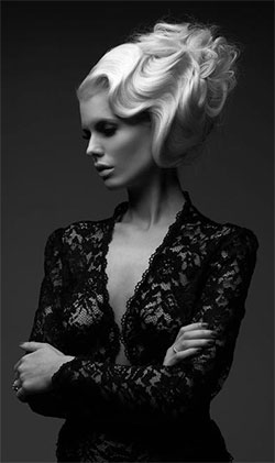 Woman with platinum blonde hair in fingerwaves style.